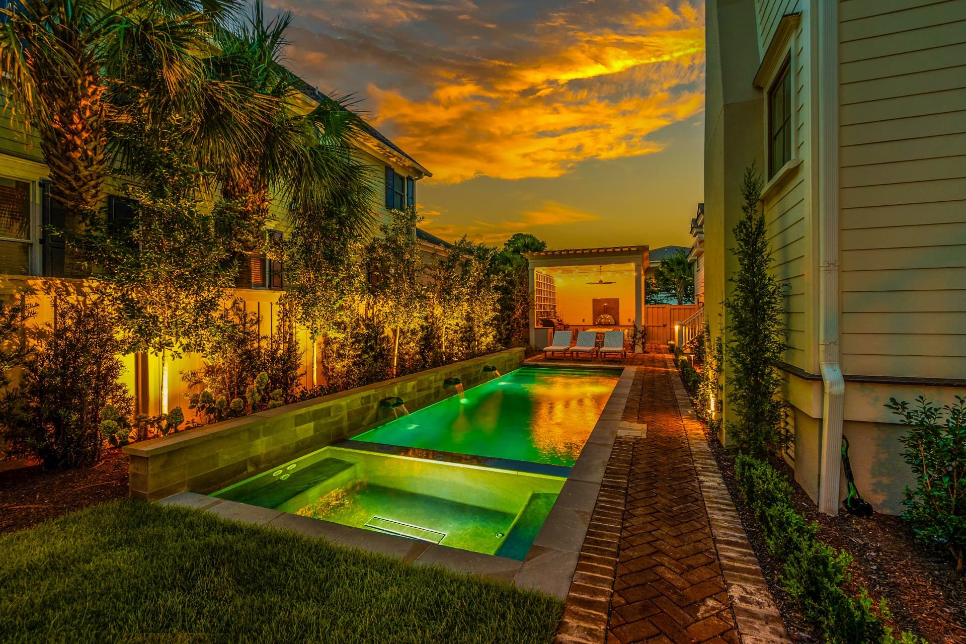 Lit side-yard lap pool — Heritage Pools project
