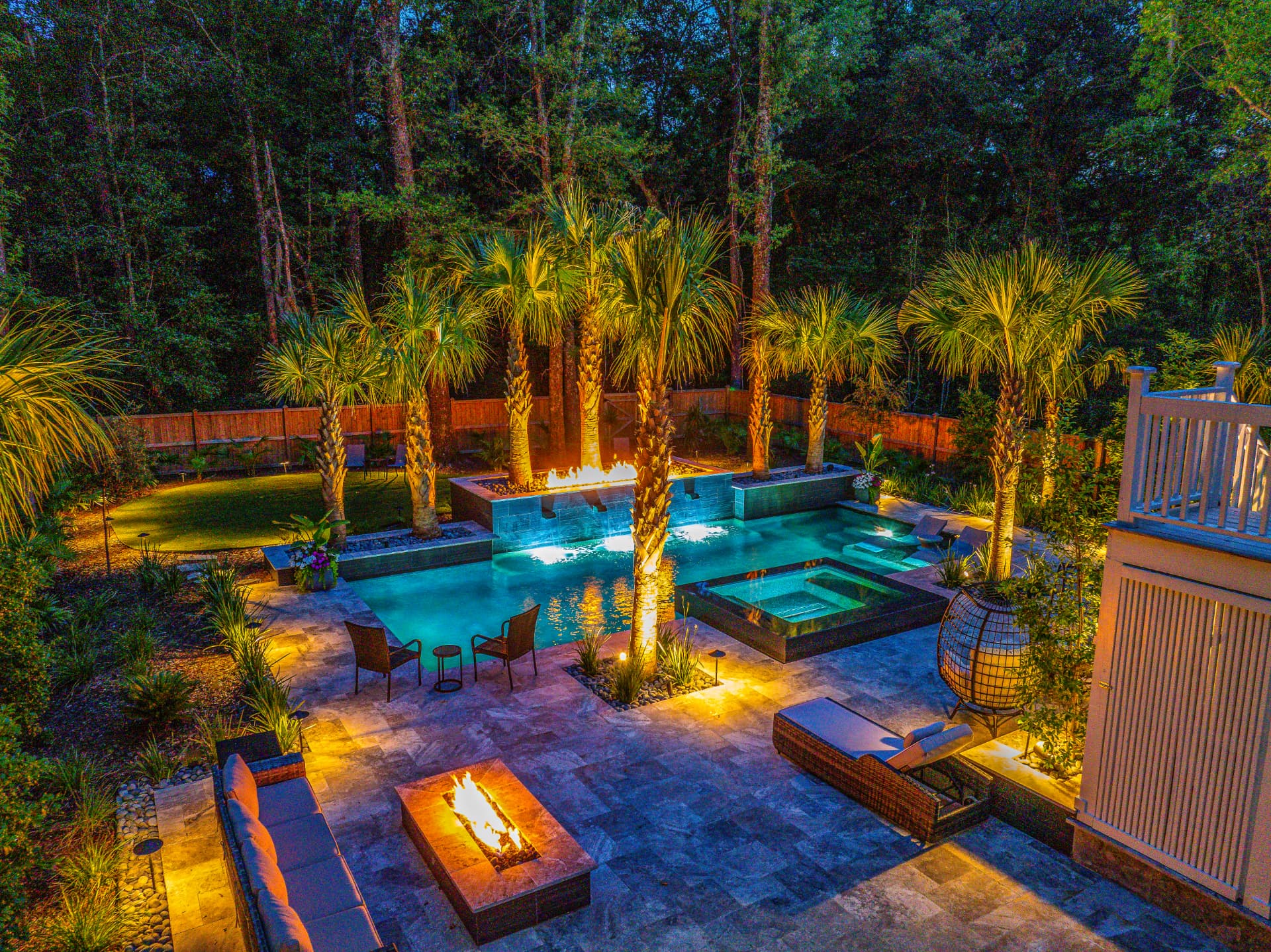 Palm courtyard with fire features — Heritage Pools project