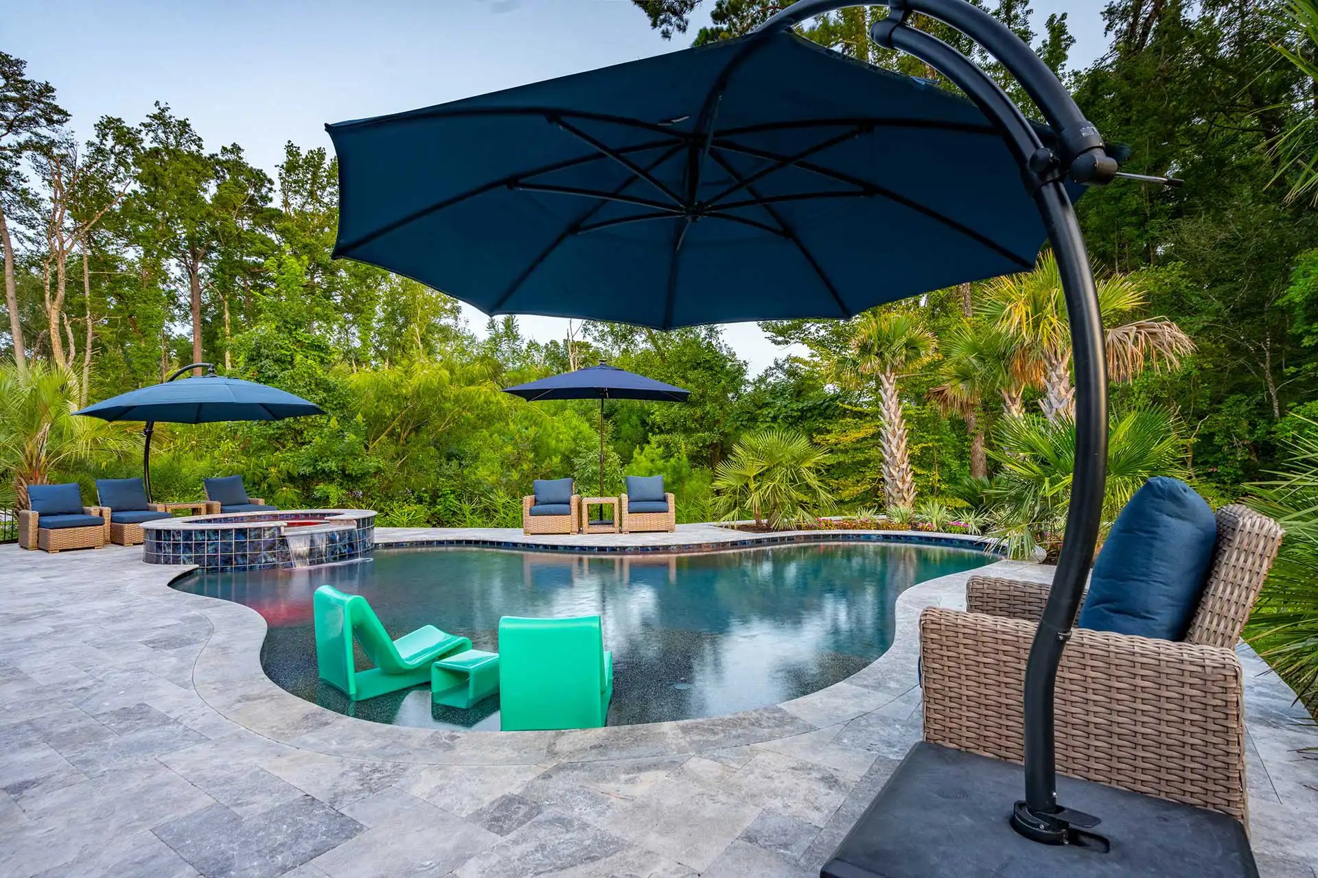 Freeform lagoon with travertine — Heritage Pools project